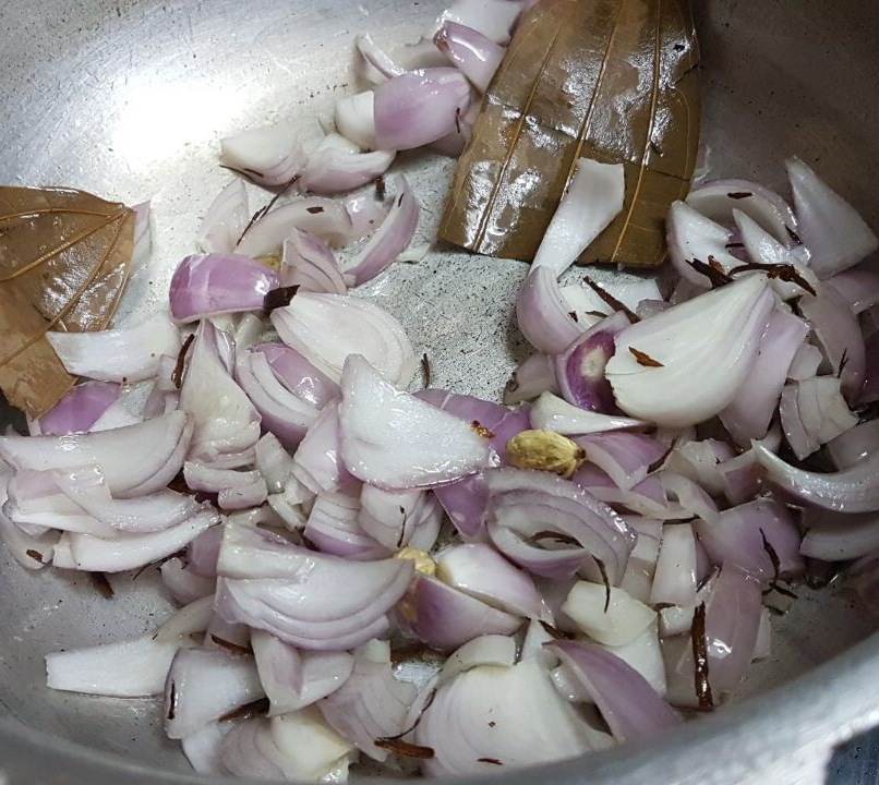 Add whole spices like cardamom bay leaf and 2 medium chopped onions